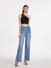 a lady in black asymmetrical one-shoulder top with straight leg jeans